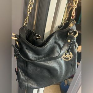 MK Michael Kors black with gold accents shoulder bag. Excellent condition.